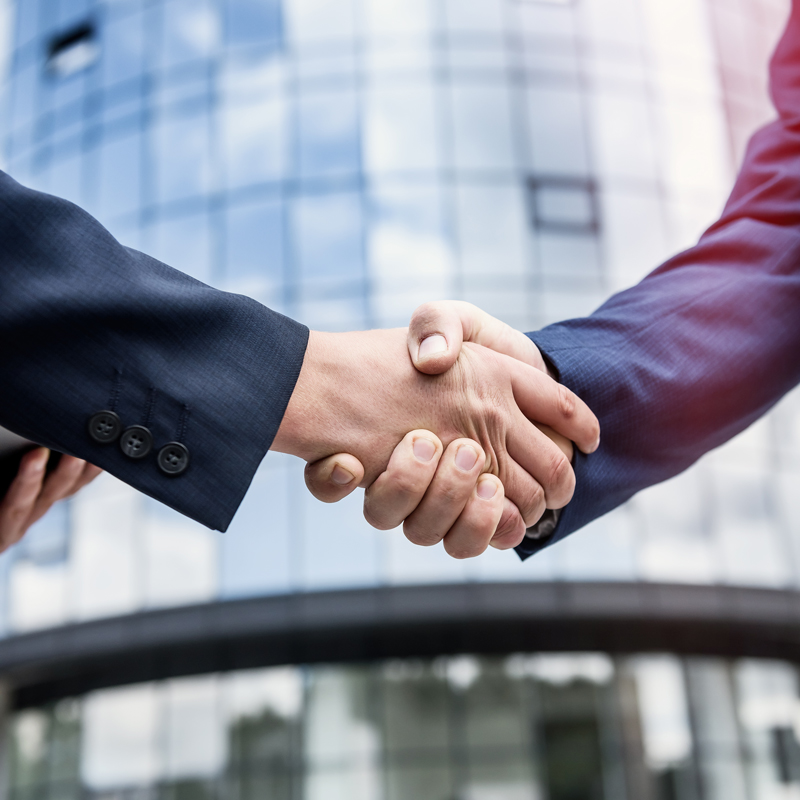 handshakes-against-new-business-center-close-up